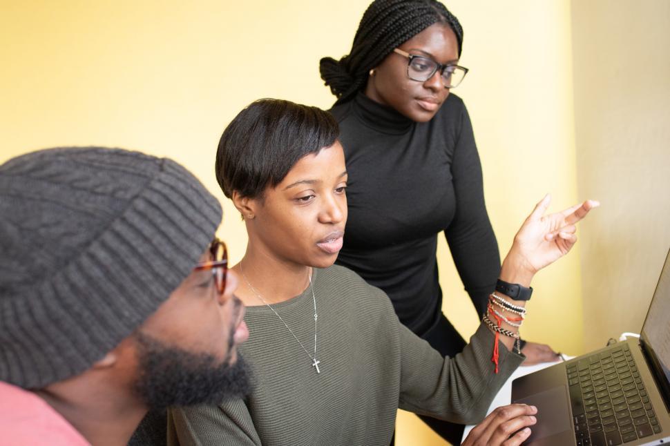 Free Image of Two Young Women and Men Working Together On Laptop 