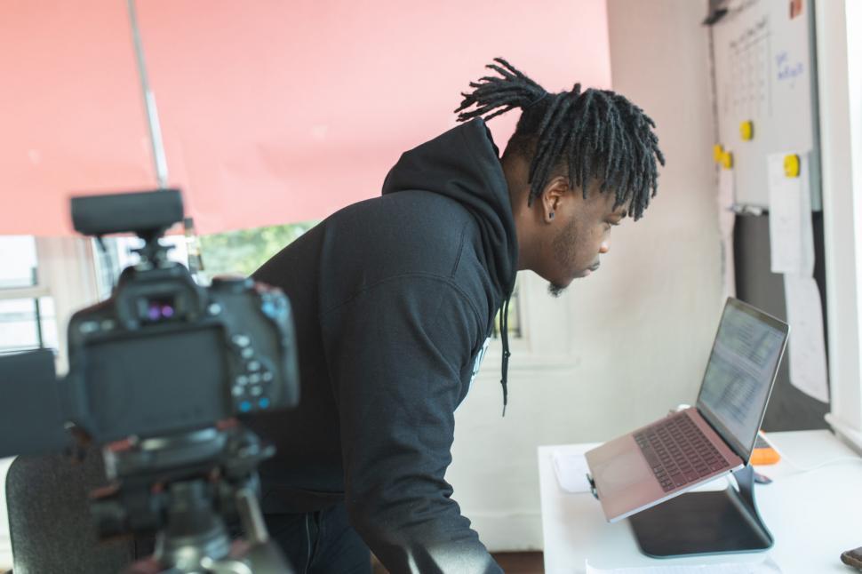 Free Image of Young Male Vlogger with laptop and camera in office 