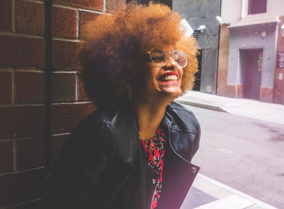 Free Image of Young Woman Leaning Against a Wall 