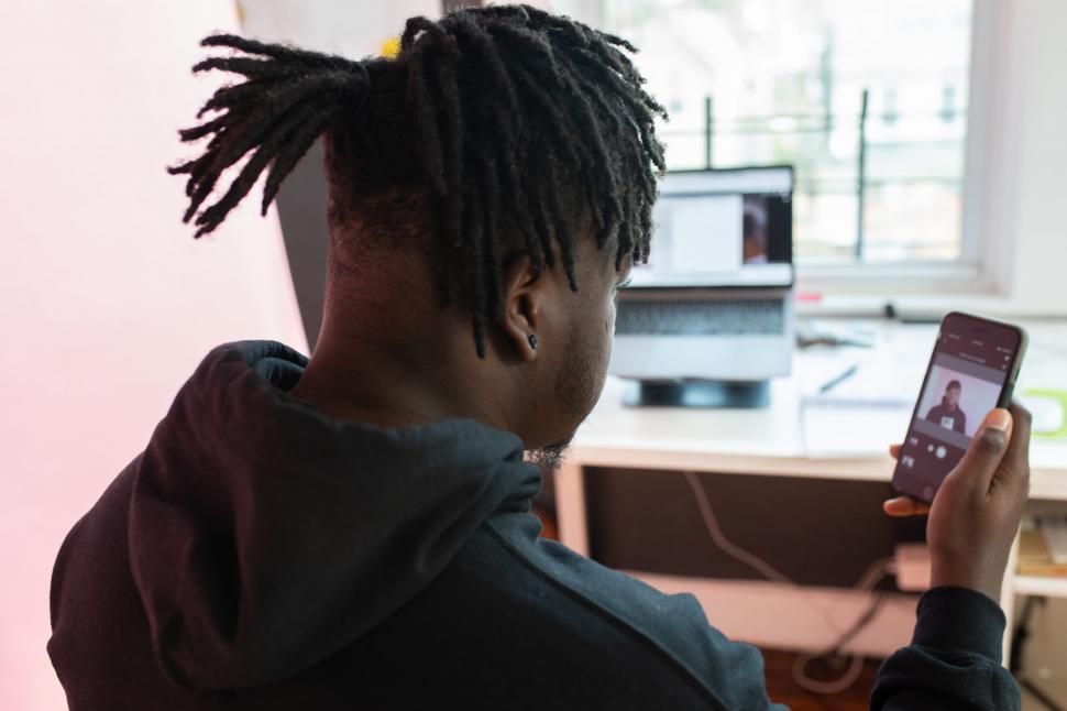 Free Image of Young Male Vlogger Checking His Video on Mobile Phone 
