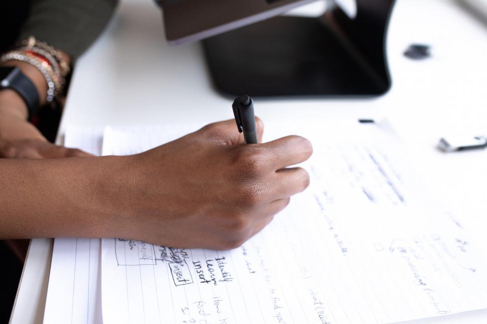 Free Image of Businesswoman Hand Writing On Paper 