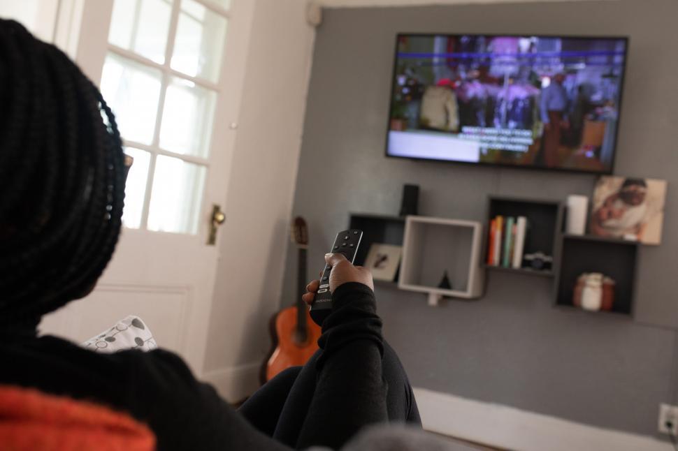 Free Image of Person Using TV Remote Control 