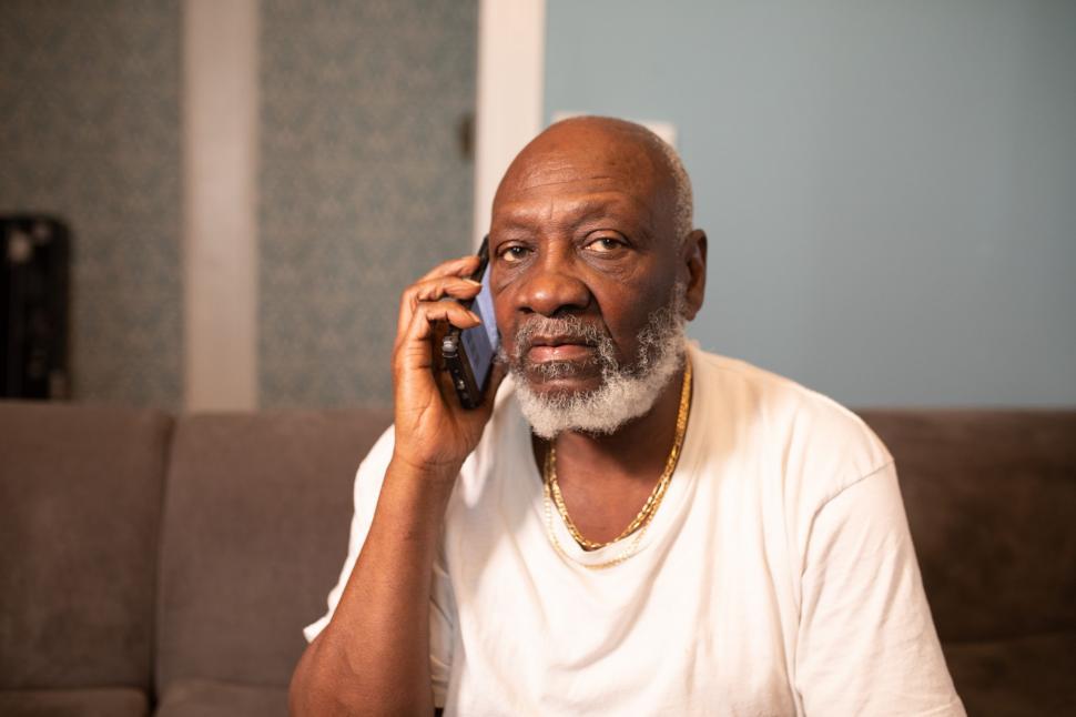 Free Image of Elderly Man Talking on Mobile phone at home 