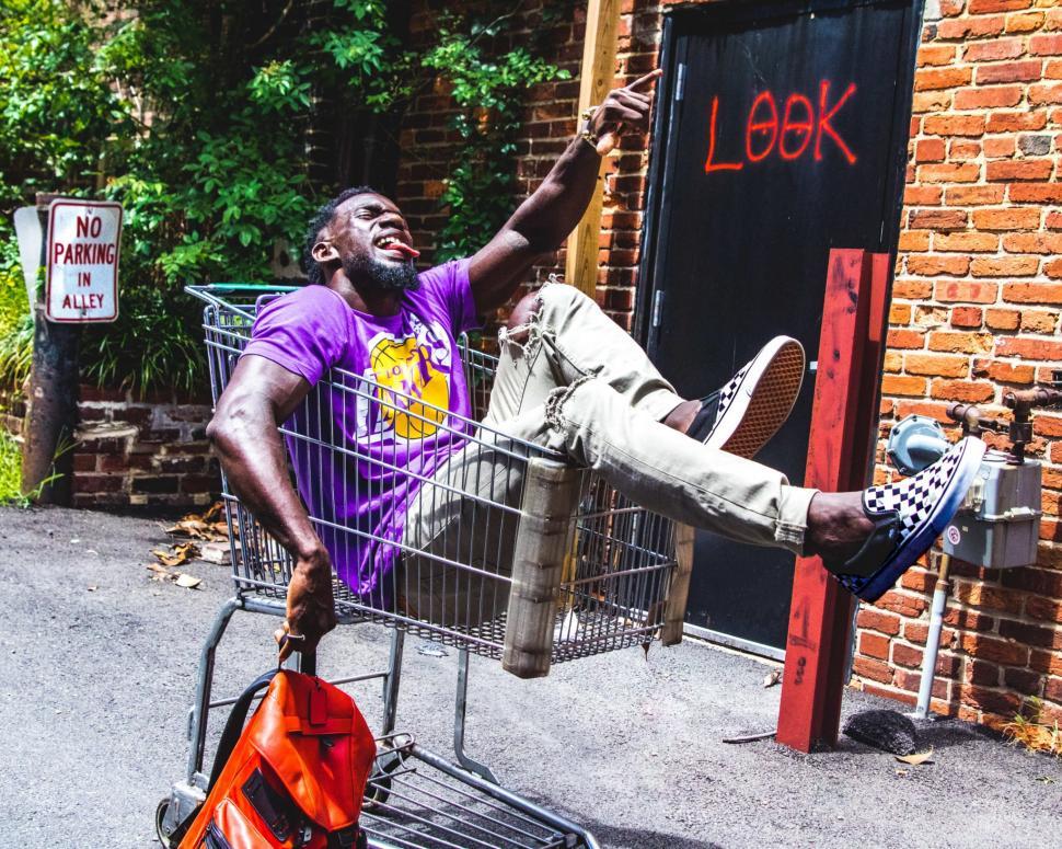 Free Image of Young Man and Shopping Cart, Having Fun 
