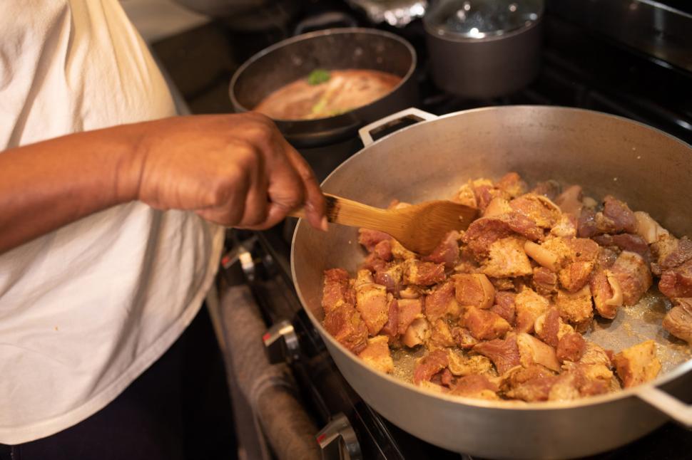 Free Image of Frying meat pieces in cooking pot 