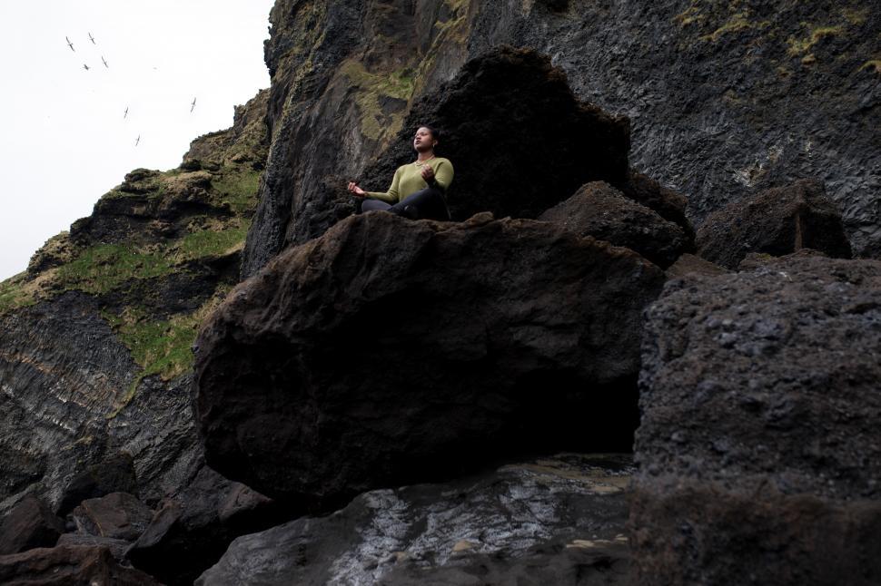 Free Image of Young Woman meditating on mountain 