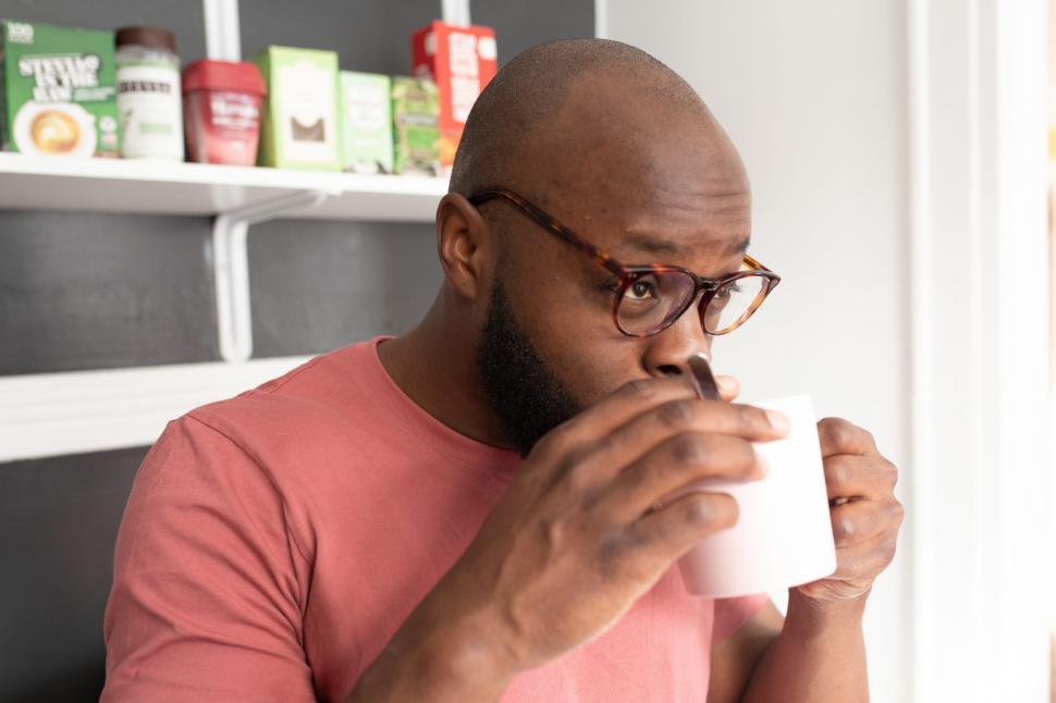Free Image of Young Man in Spectacles Holding a Coffee Mug 
