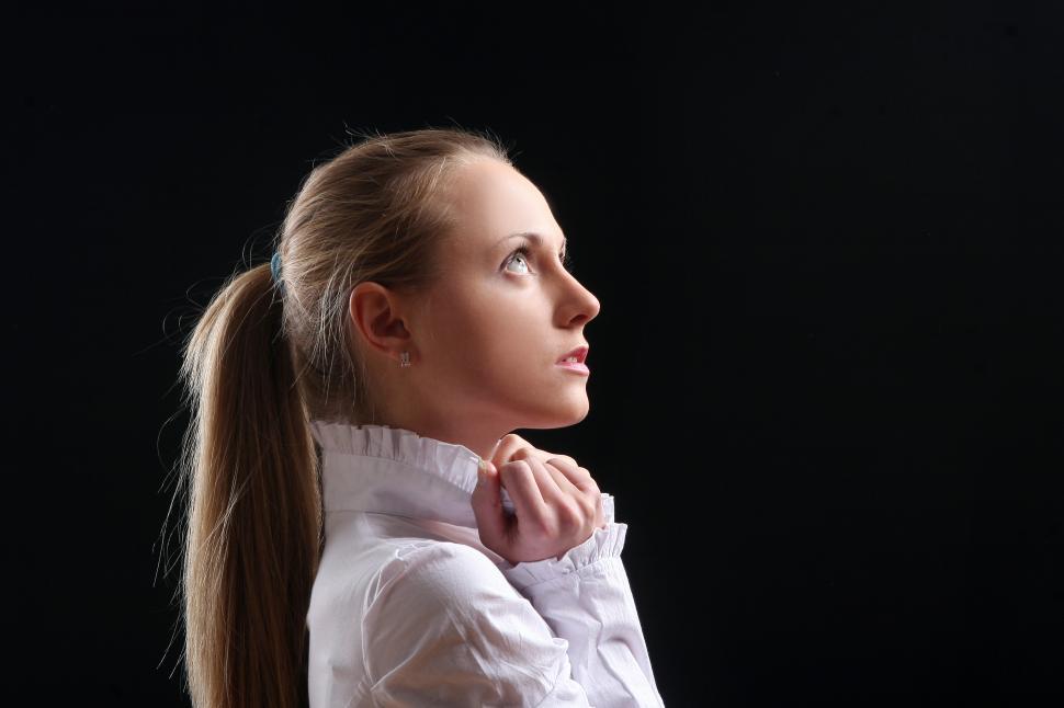 Free Image of beautiful young woman on black looking up 