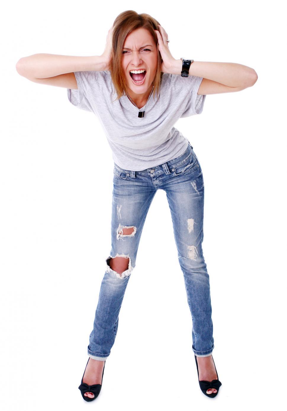 Free Image of Closeup portrait of young girl screaming against white backgr 