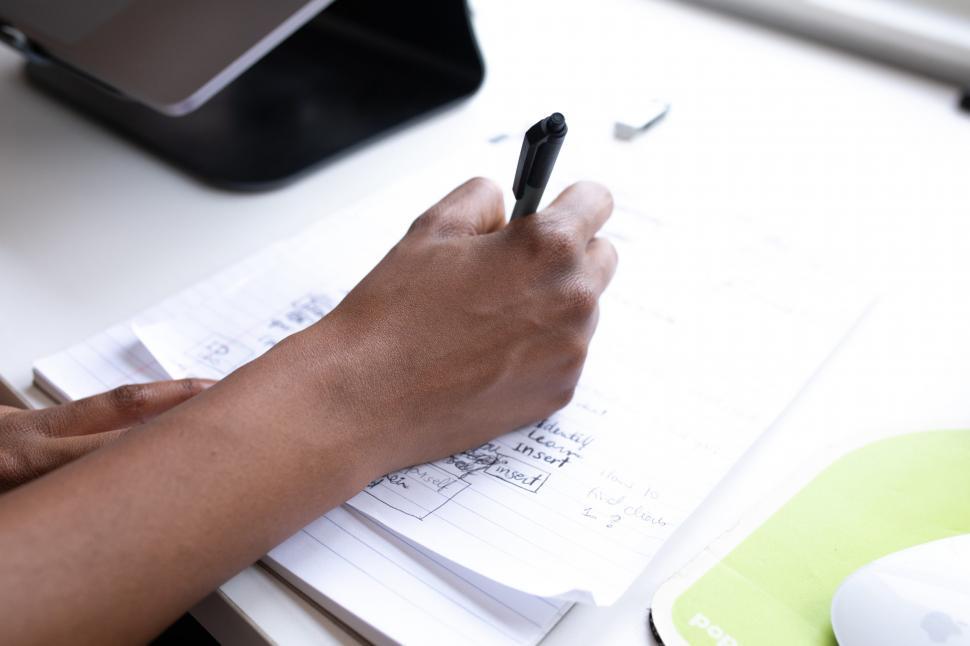 Free Image of Hand Of Businesswoman Writing On Paper 