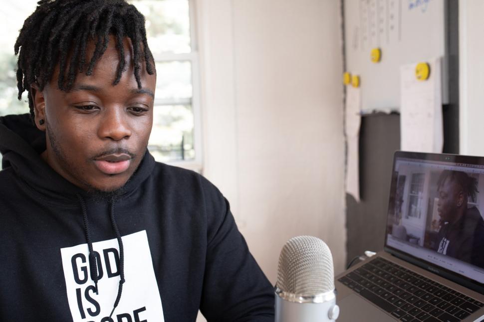 Free Image of Young Male Vlogger with mic and laptop 