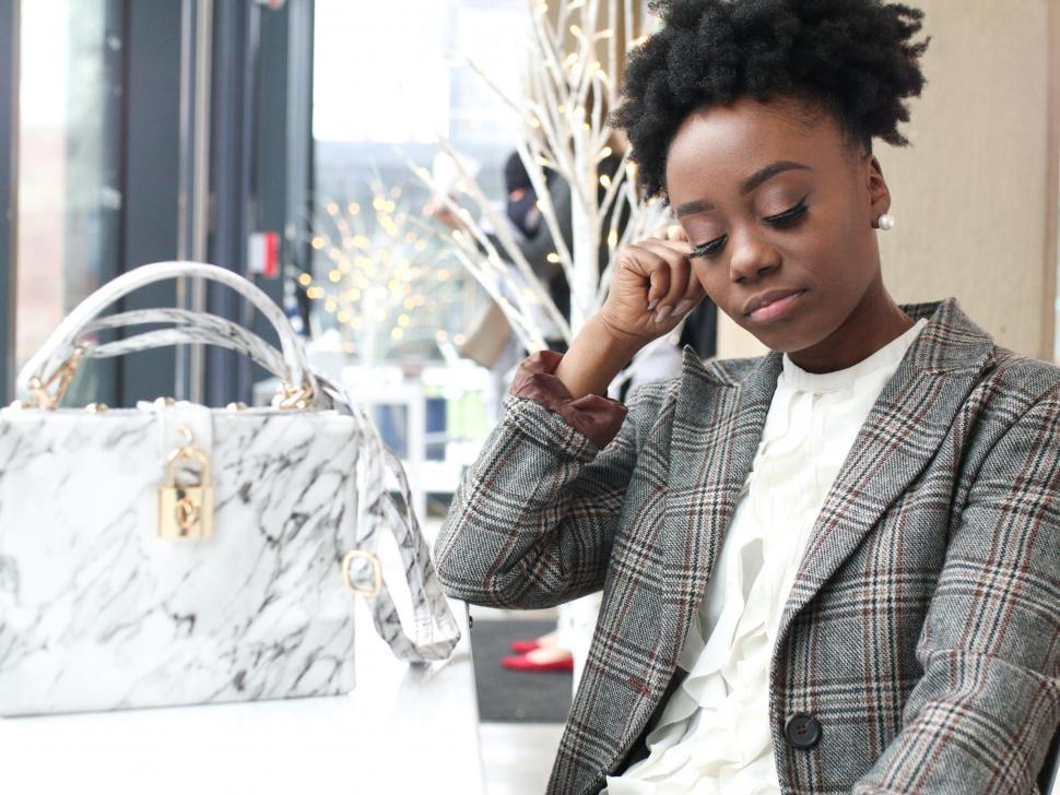 Free Image of Young business woman in tweed blazer - looking down 