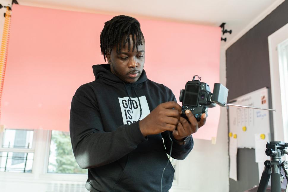 Free Image of Young Man With Professional Camera at workplace 