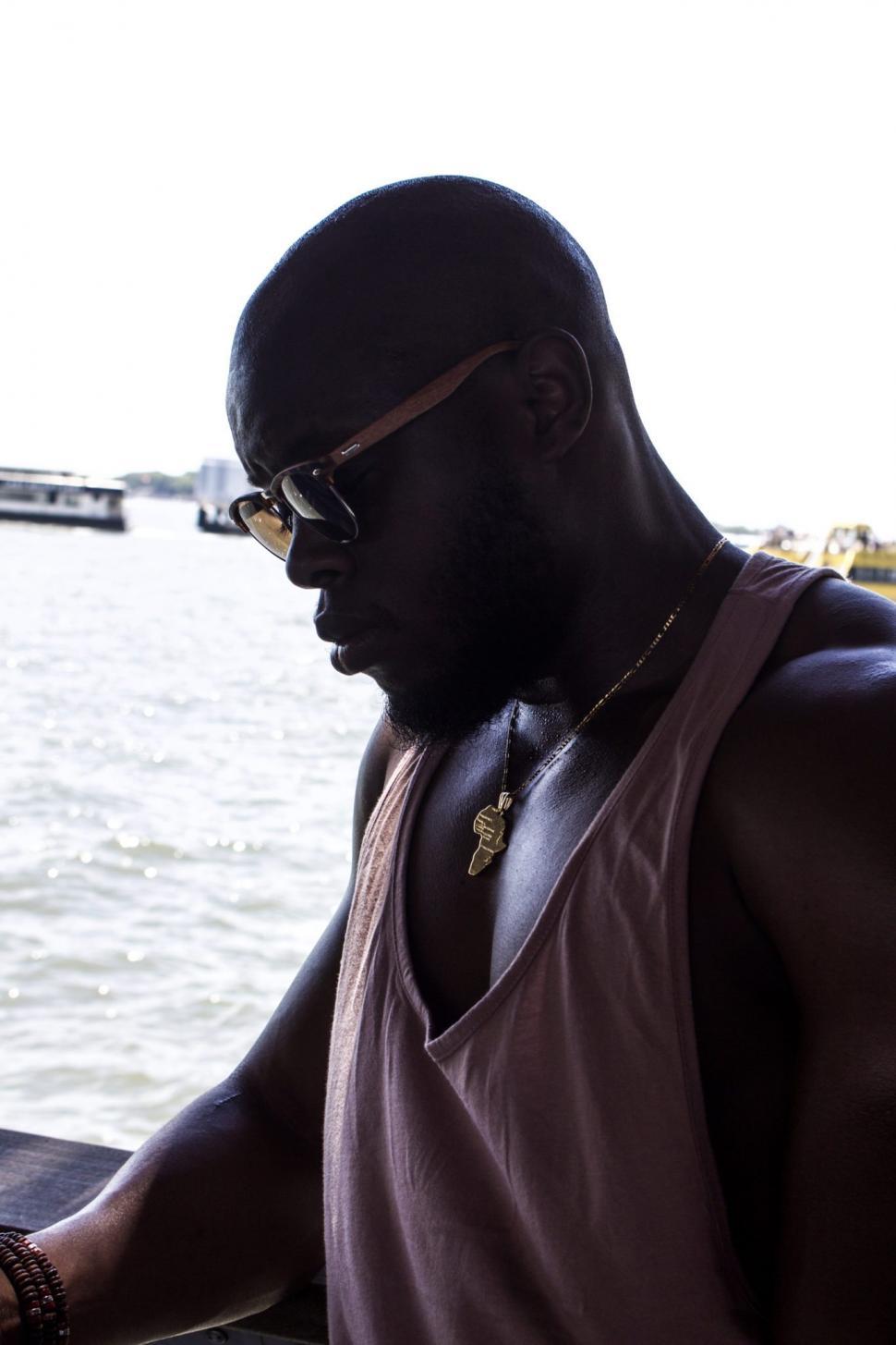 Free Image of Young Man with Golden Africa Map Pendant 