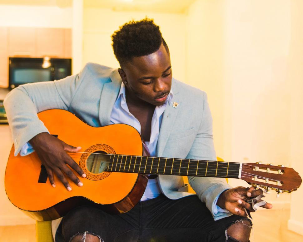 Free Image of Young Man in Blue Blazer With Guitar 