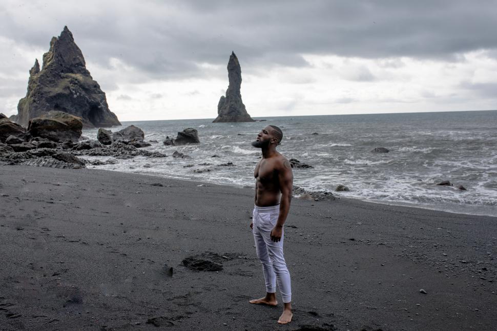 Free Image of Young Shirtless Man with long beard at Seashore 