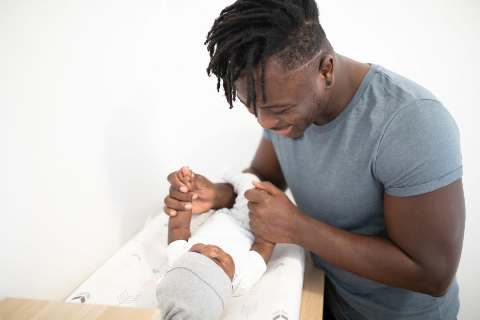 Free Image of Young Smiling Father With cute little baby 