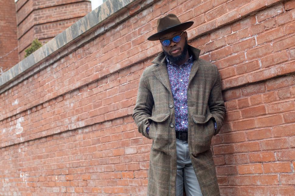 Free Image of Young Stylish man in tweed overcoat with hands in pockets 