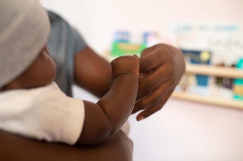 Free Image of Little Baby Holding Fathers Hand 