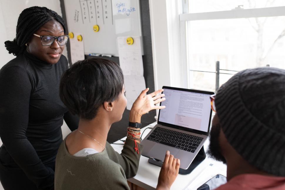 Free Image of Three Young Coworkers Working Together On Laptop 