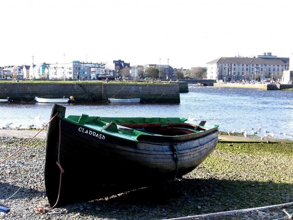 Free Image of Boat Resting on Beach by Water 
