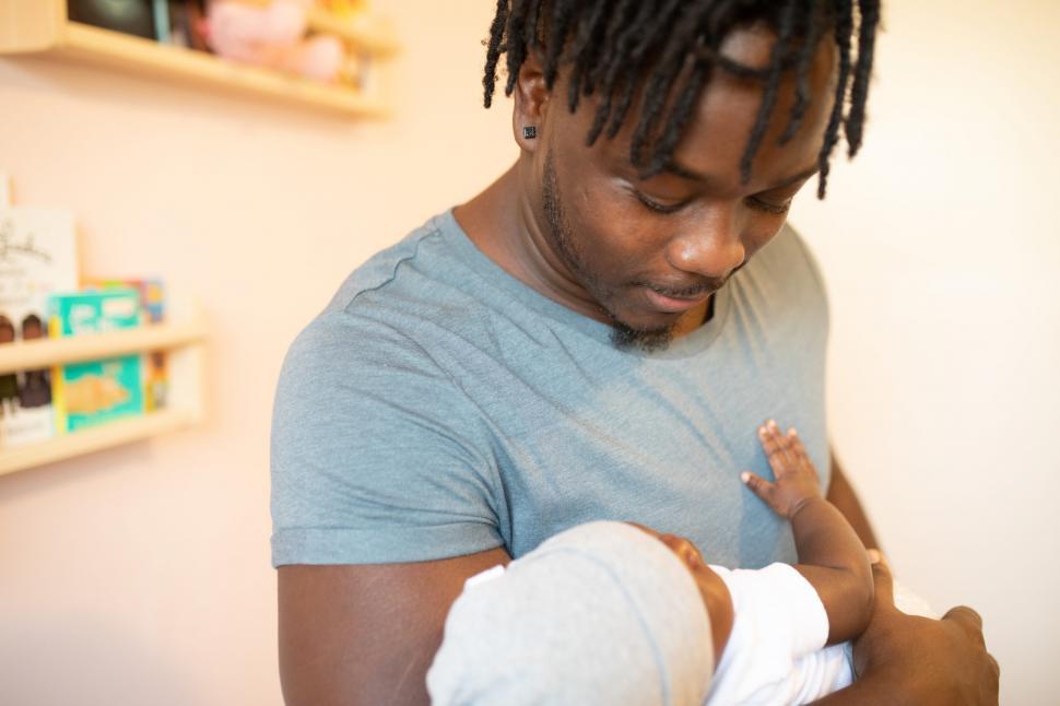 Free Image of Young Father caring his cute little baby 