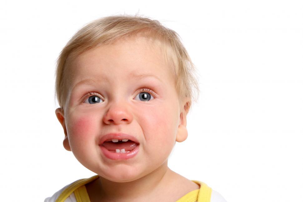 Free Image of a funny kid isolated on white, looking at something interesting 