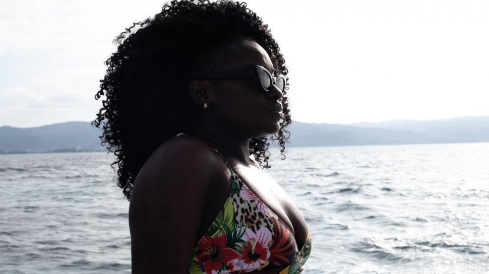 Free Image of Young Woman in Sunglasses relaxing on a boat 