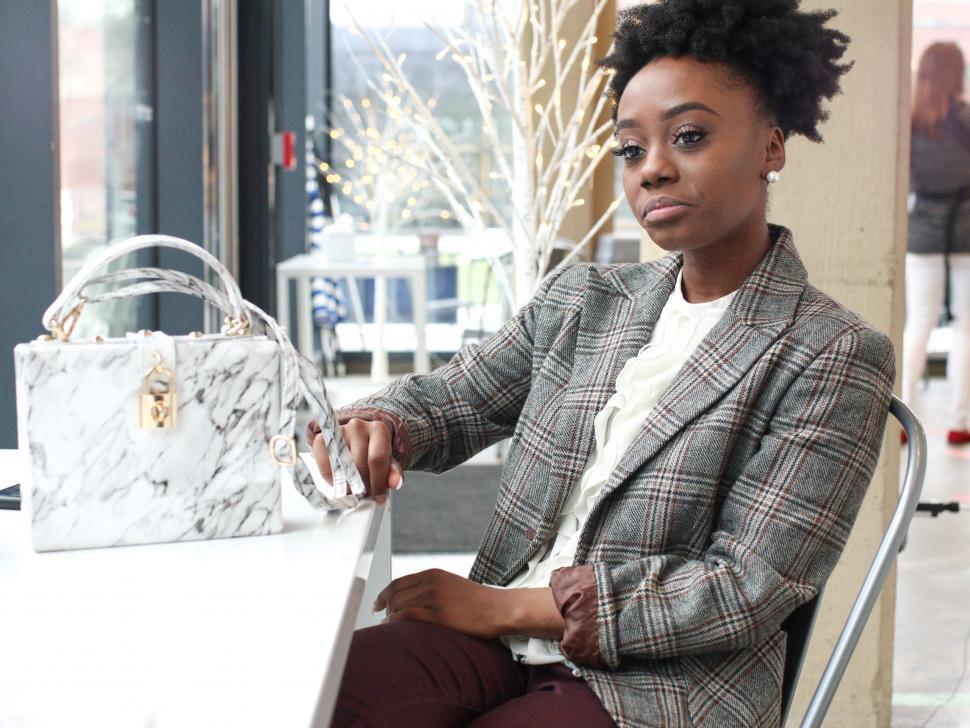 Free Image of Young business woman in tweed blazer - looking thoughtful 
