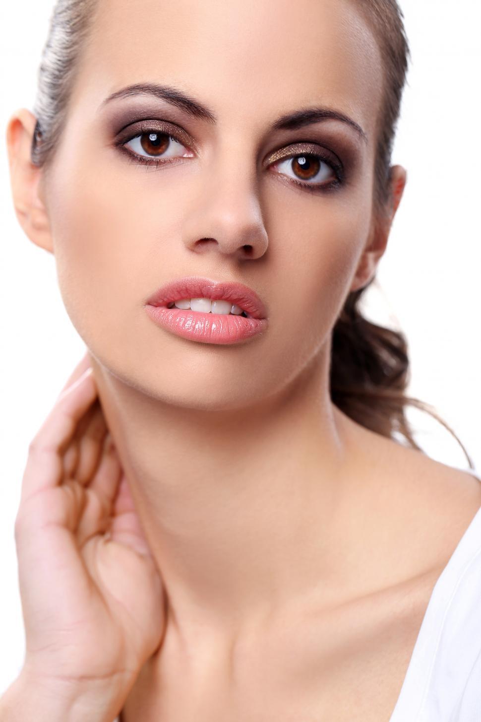 Free Image of Beautiful woman with hair pulled back on a white background 