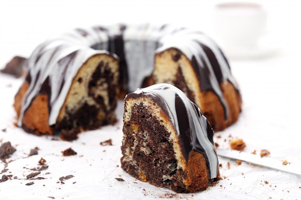 Free Image of Delicious bundt cake, frosted and sliced 