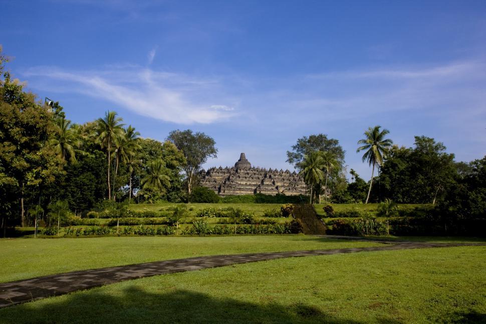 Free Image of Lush Green Field With Stone Building 