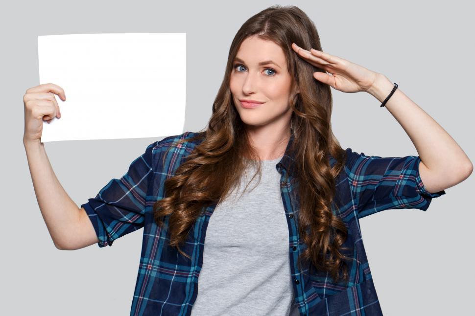 Free Image of Woman saluting, holding blank white card 