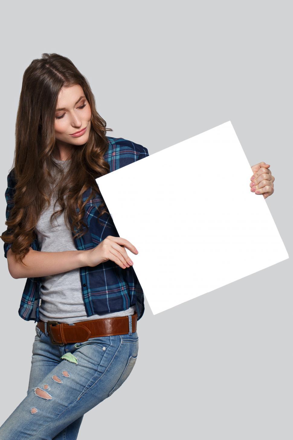 Free Image of Jaunty angle blank sign held by woman 