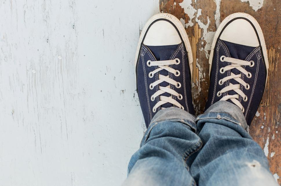 Free Image of Man in sneakers, looking down at feet, copyspace 