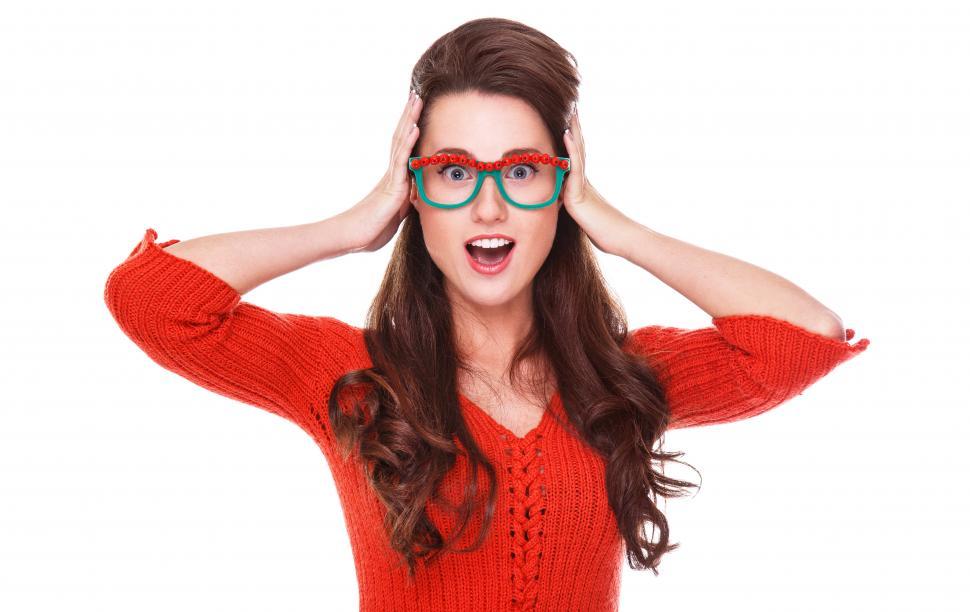 Free Image of Quirky woman in red sweater is surprised 