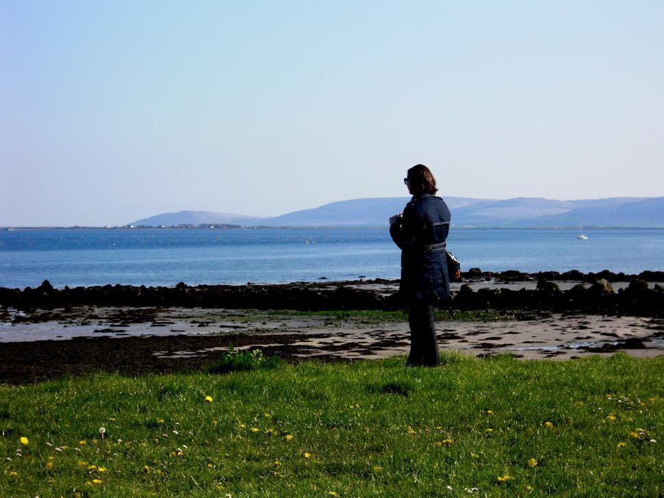 Free Image of Person Standing on Top of Lush Green Field 
