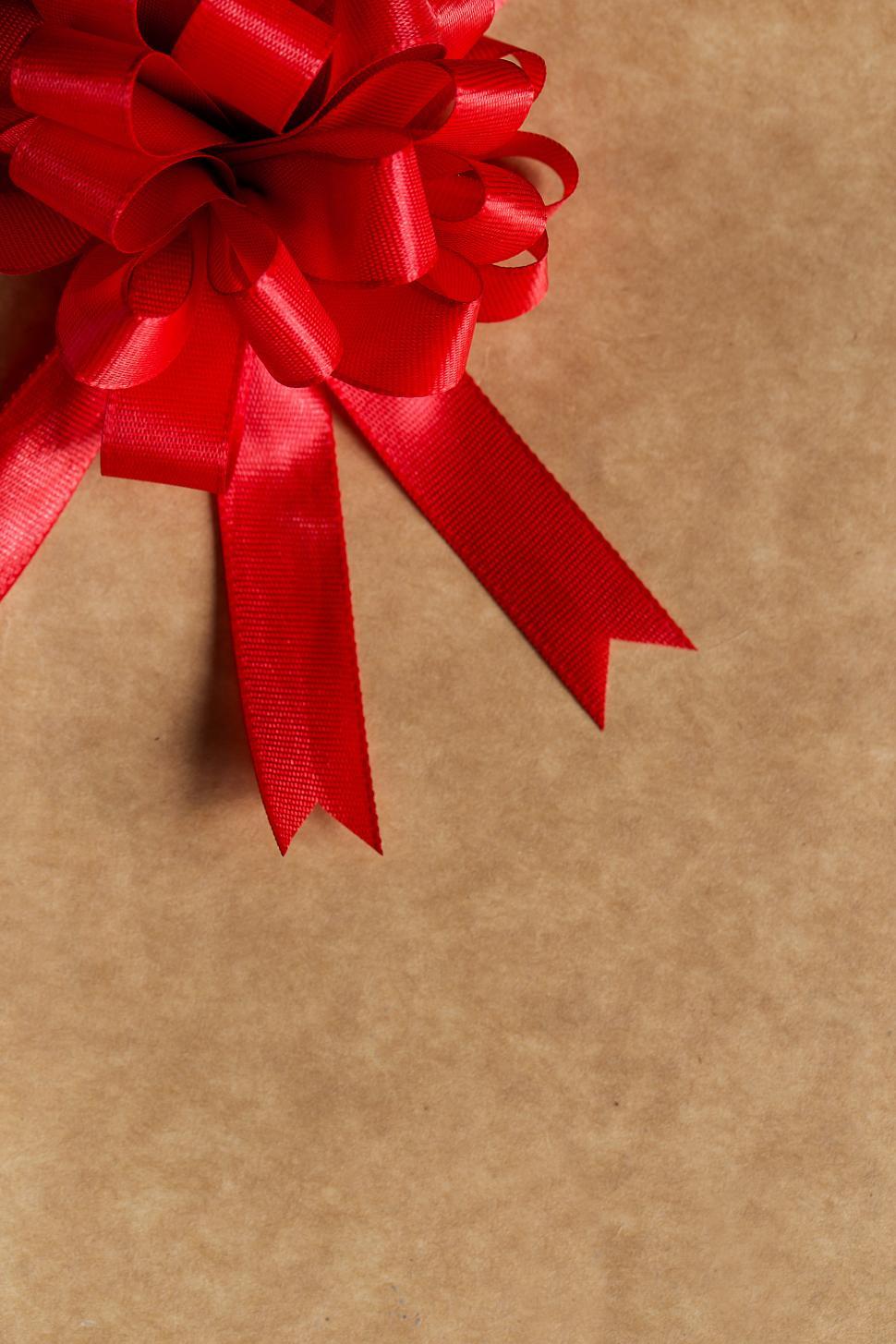 Free Image of Gift, celebration. Red, gorgeous bow on the table 