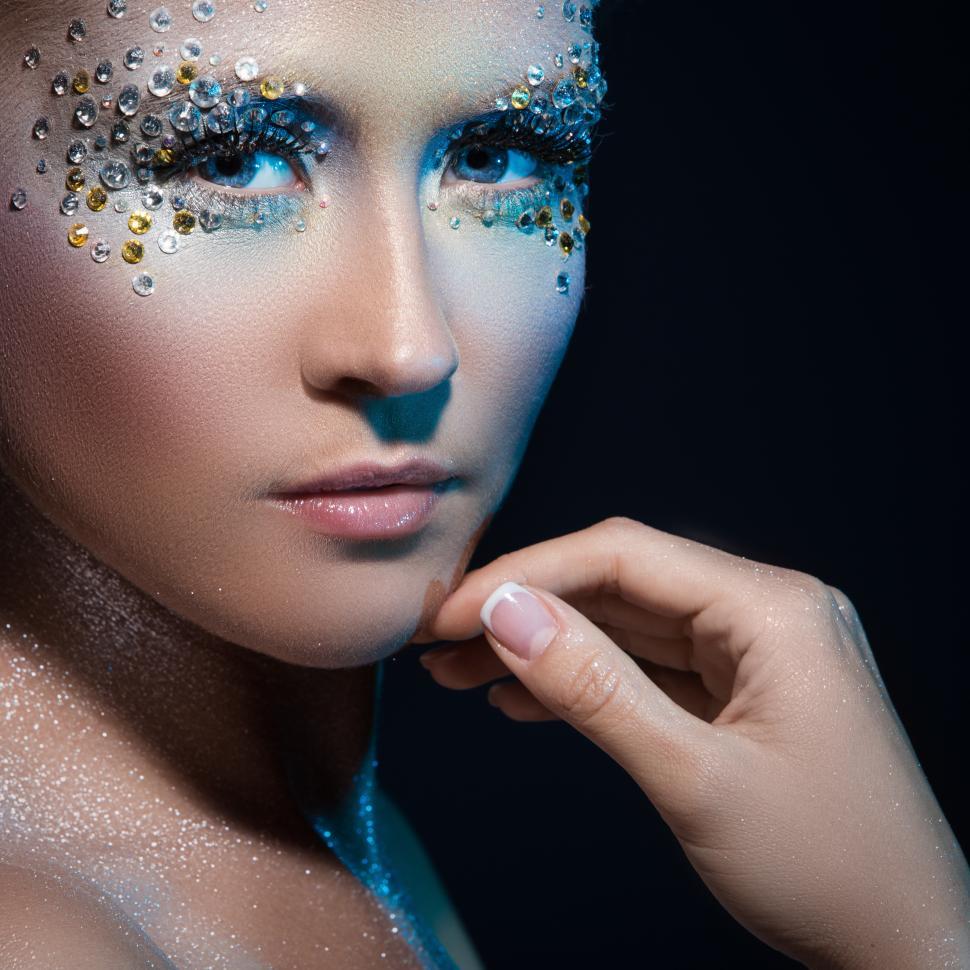 Free Image of Attractive woman on dark background with artistic make-up 