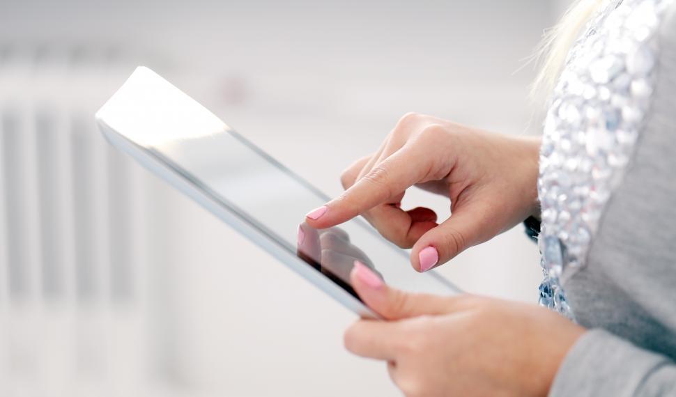 Free Image of Woman navigating on a tablet 