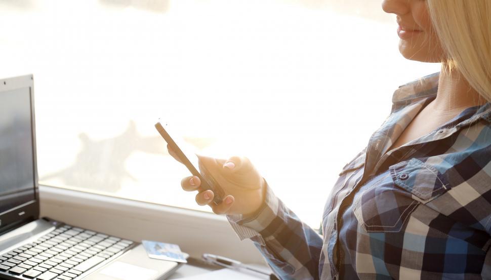 Free Image of Girl with a phone in a bright room 