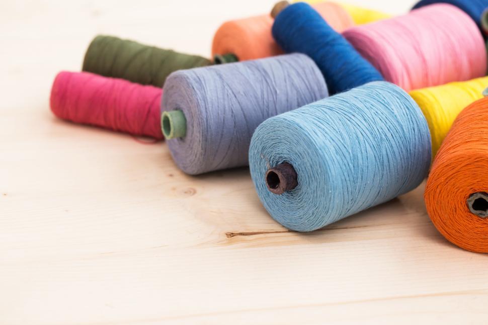 Free Image of Spools of colorful threads on the table 