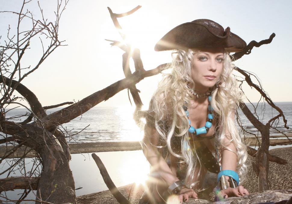 Free Image of blonde woman in pirate outfit on the beach 