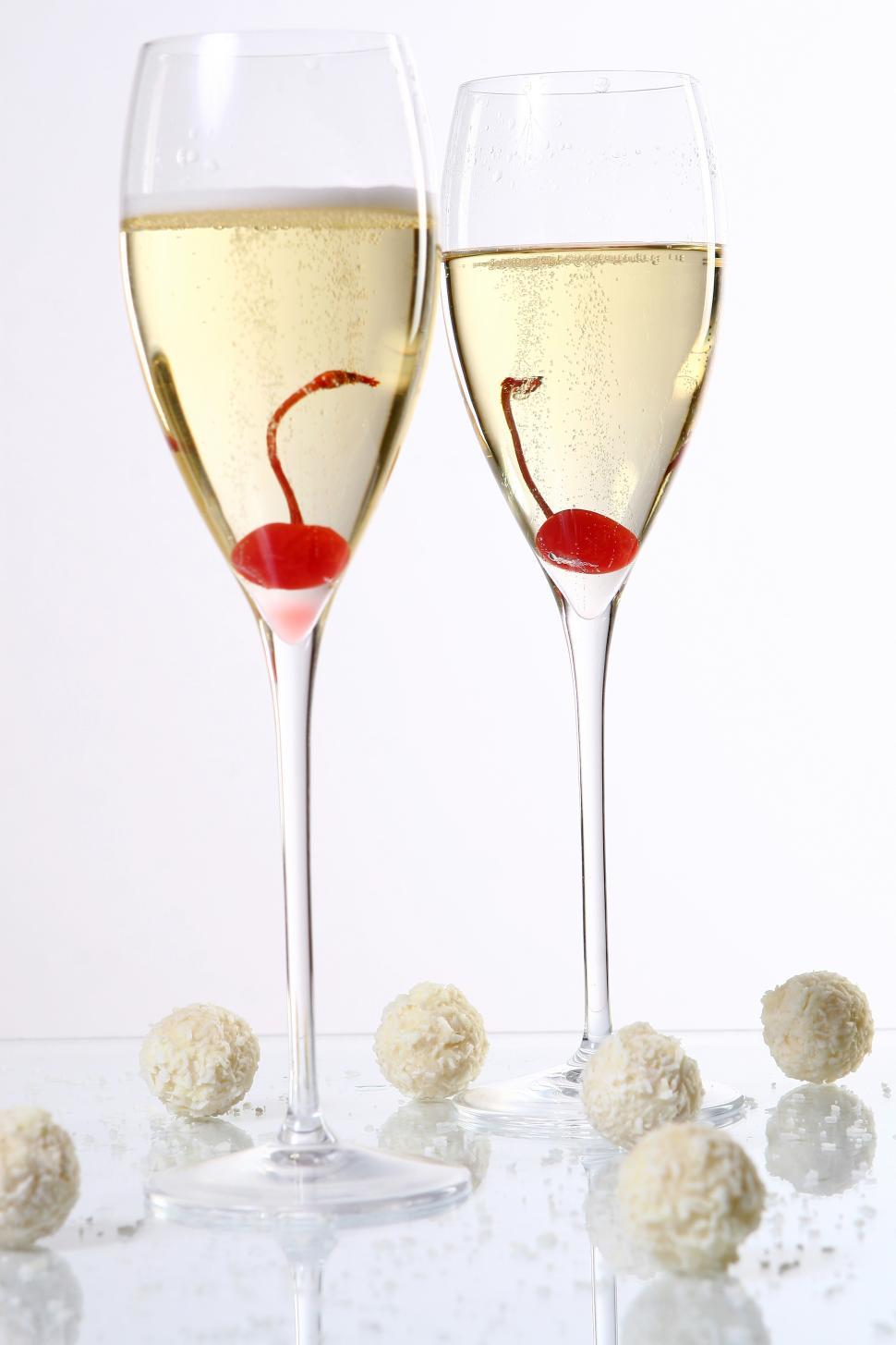 Free Image of two glasses with champagne and cherries 