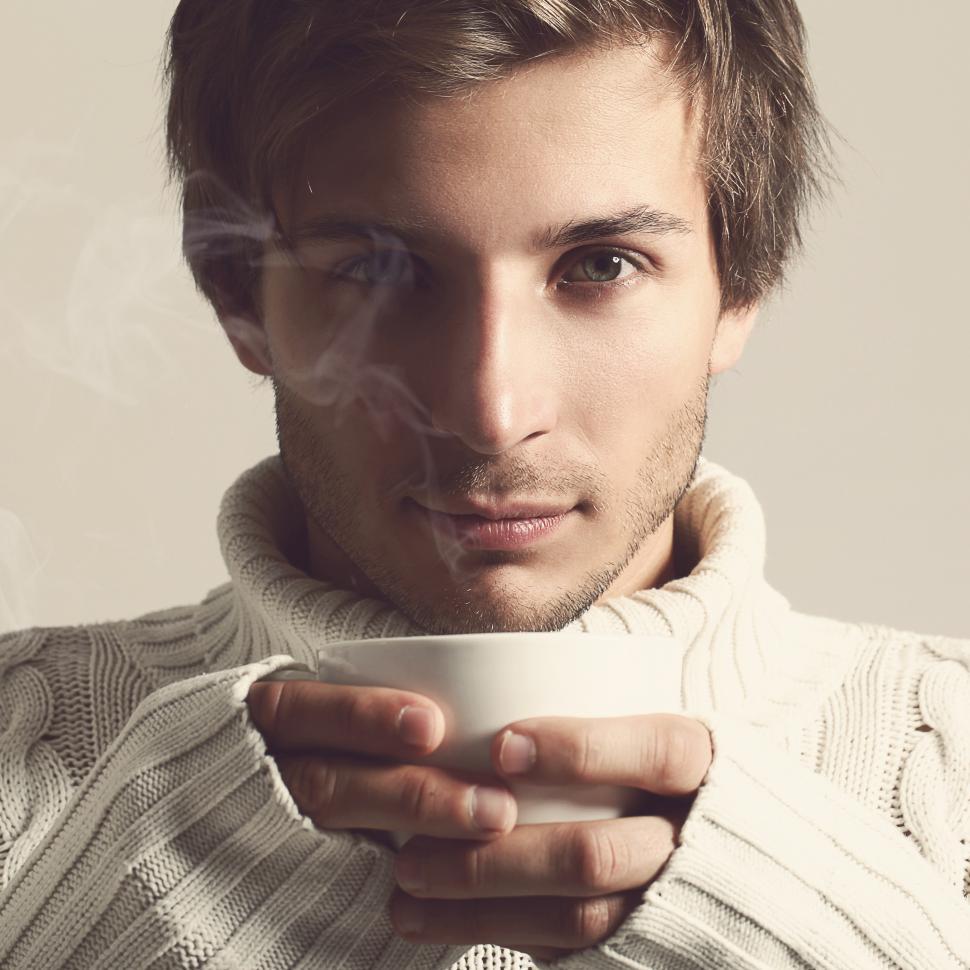 Free Image of Handsome man in sweater with hot beverage 