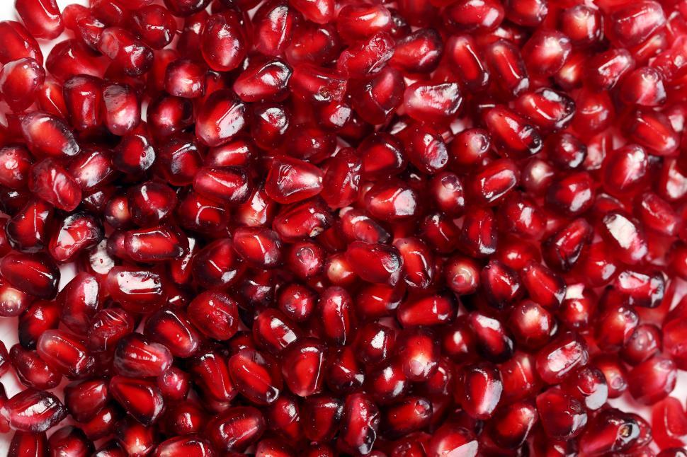 Free Image of Background of pomegranate seeds on white background 