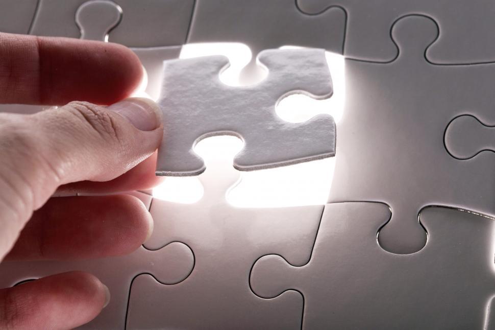 Free Image of White puzzle lit from behind - finding the right piece 