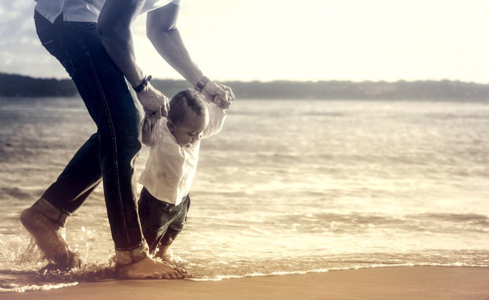 Free Image of Baby Taking First Steps with Fathers Help 