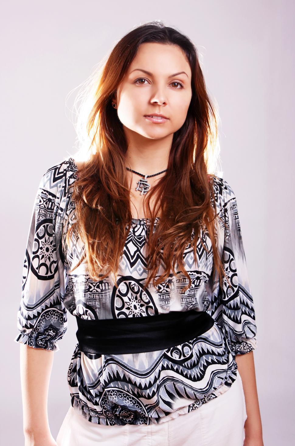 Free Image of Young woman standing and looking at camera 