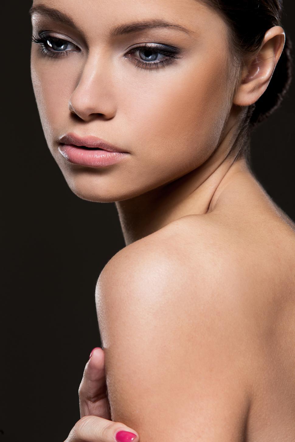 Free Image of Model posed on black background, bare shoulders 